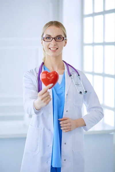 Médecin féminin avec le stéthoscope tenant le cœur — Photo