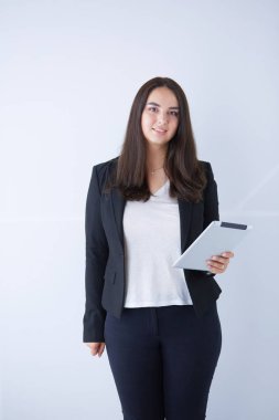 Genç iş kadını onun elinde dijital tablet ile gülümseyen portresi.