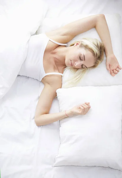 Красивая женщина лежит на кровати дома — стоковое фото