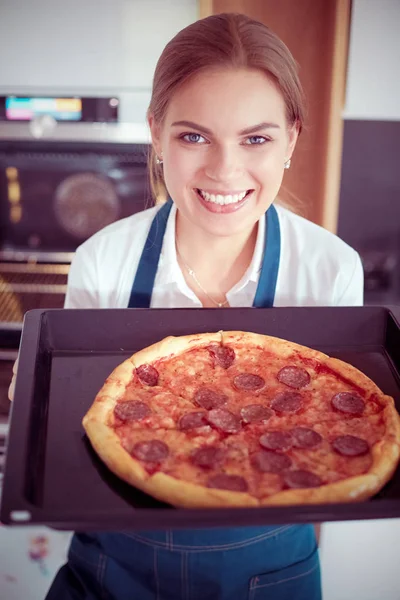 Mutlu genç bayan evde pizza pişiriyor. — Stok fotoğraf