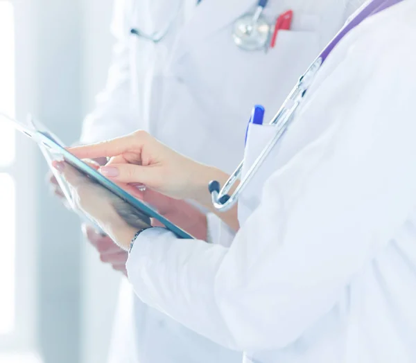 Two doctors holding a folder and talking about patient — Stock Photo, Image
