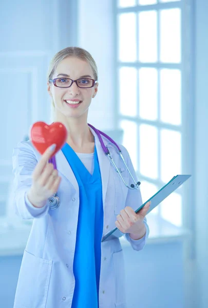 Dokter wanita dengan stetoskop memegang jantung — Stok Foto