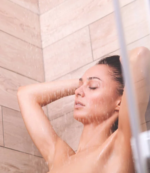 Young beautyful woman under shower in bathroom. — Stock Photo, Image