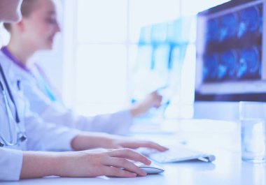 Hastanede bilgisayarla çalışan iki genç bayan doktor..