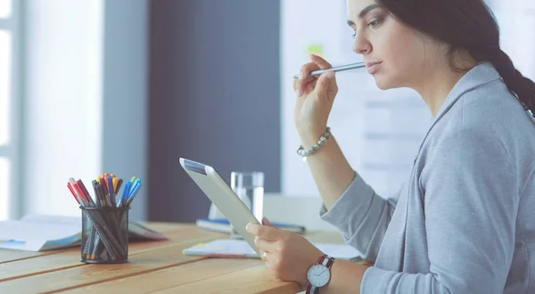 Pretty young female manager using modern digital tablet at office. — Stock Photo, Image