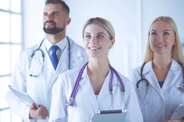 Smiling doctors all standing together as they work