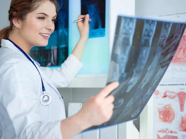 Jonge vrouwelijke arts kijkt naar de röntgenfoto van de longen in het ziekenhuis — Stockfoto