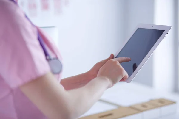 Doctor woman checking medical data on tablet pc