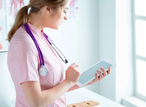 Doctor woman checking medical data on tablet pc