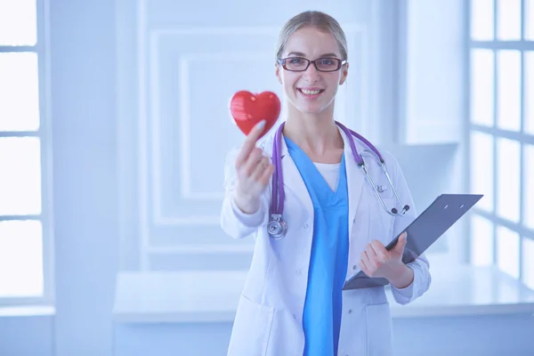 Médecin féminin avec le stéthoscope tenant le cœur — Photo