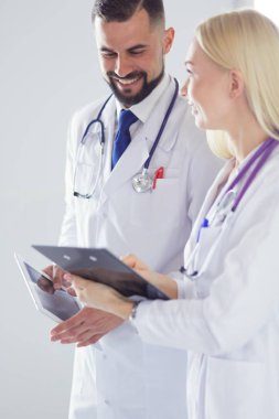 Two doctors holding a folder and talking about patient clipart