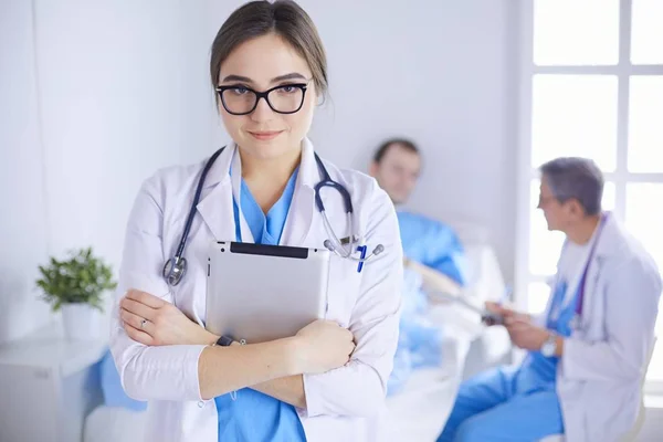 Female doctor using tablet computer in hospital lobby