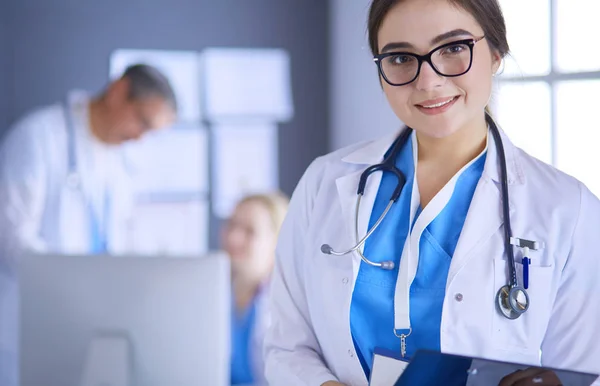 Female doctor using tablet computer in hospital lobby