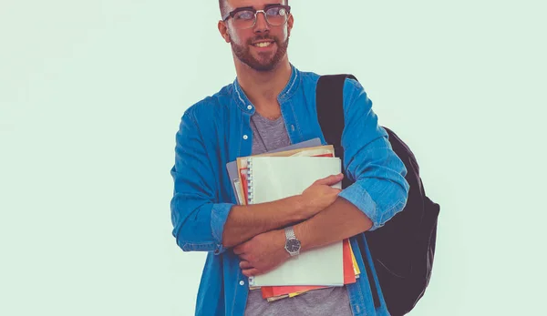 Un estudiante masculino con una bolsa de la escuela sosteniendo libros aislados sobre fondo blanco. Oportunidades educativas. Estudiante universitario . — Foto de Stock