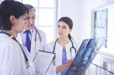 Bir grup doktor hastanede röntgenleri kontrol ediyor.