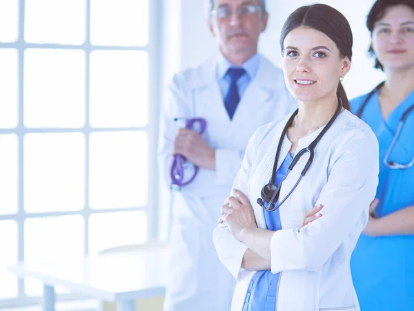 Group of doctors and nurses standing in a hospital room — Stock Photo, Image