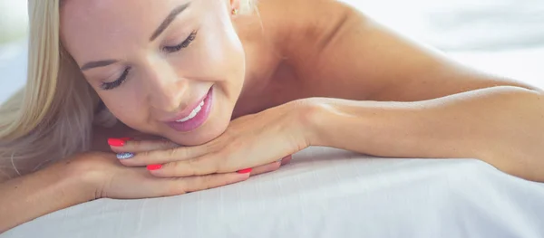 Relaxed woman getting back massage in spa center