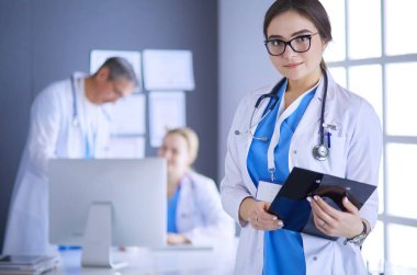 Hastane lobisinde tablet bilgisayar kullanan kadın doktor.