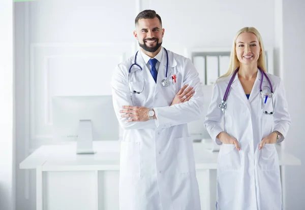 A medical team of doctors, man and woman,in a consultancy room