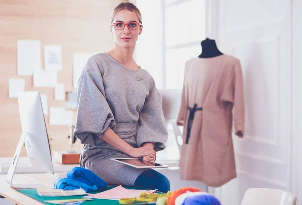 Beautiful fashion woman designer standing in studio