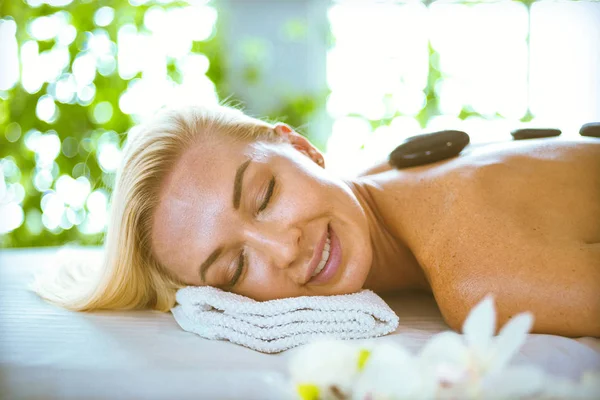 Young woman lying on a massage table,relaxing with eyes closed. Woman. — Stock Photo, Image