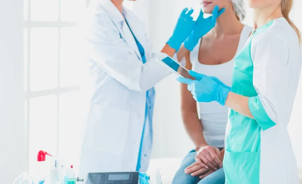 Beautiful woman face near doctor with syringe — Stock Photo, Image