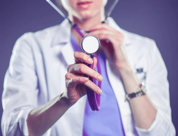 A young female doctor listening , holding stethoscope — Stock Photo, Image