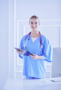 Üniformalı bir dosyayla gülümseyen kadın doktor