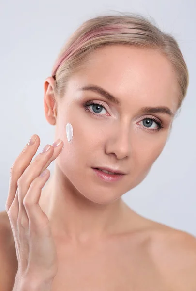 The beautiful young girl with a clean fresh skin touches with a hand a cheek — Stock Photo, Image