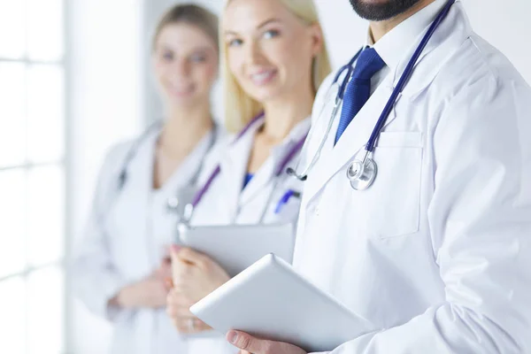 A medical team of doctors, man and women, isolated on white background