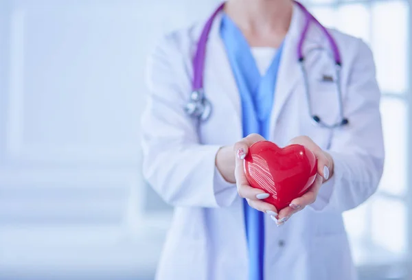 Doctor with stethoscope holding heart, isolated on white background — Stock Photo, Image