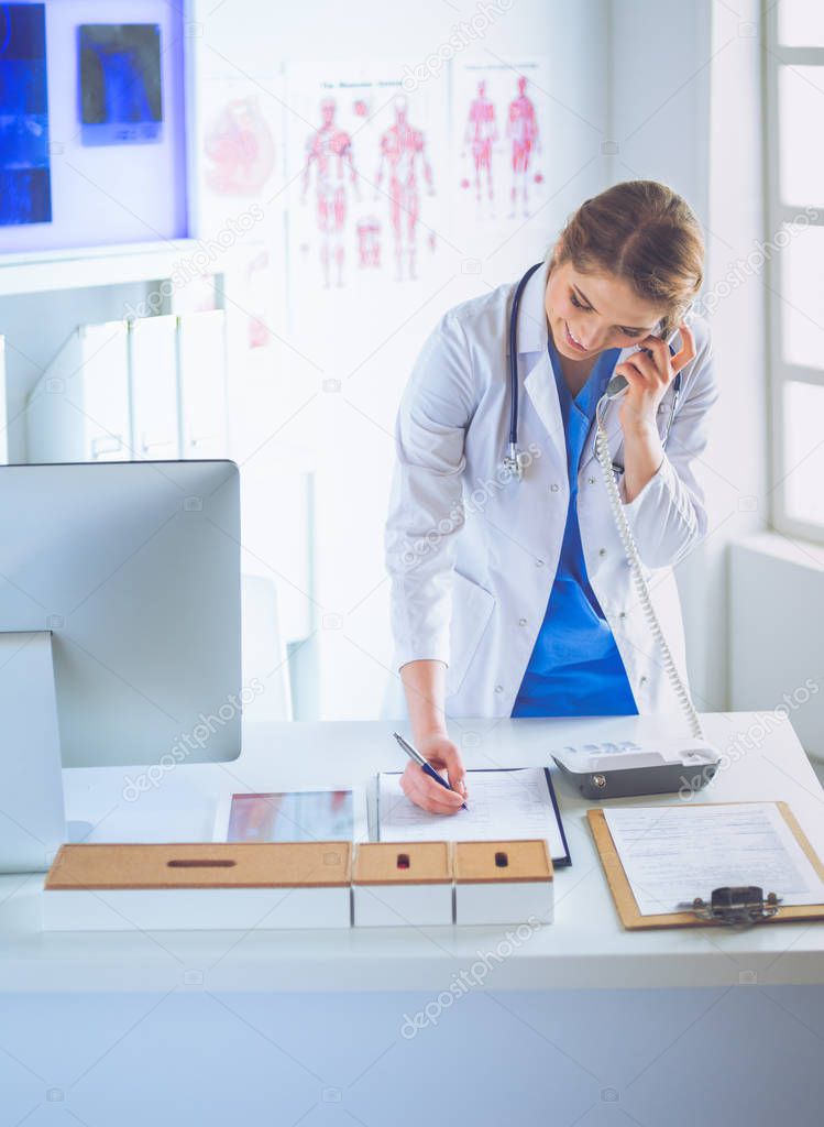 Serious doctor on the phone in her office