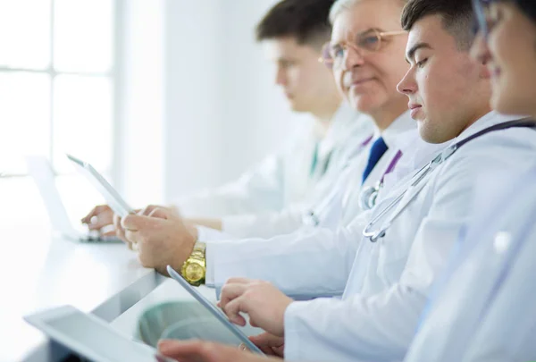 Medical team sitting and discussing at table — Stock Photo, Image