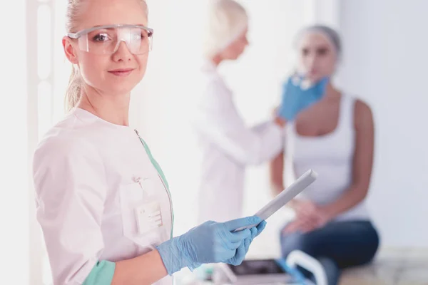 Beautiful woman face near doctor with syringe. — Stock Photo, Image