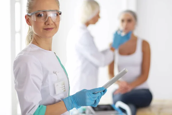 Beautiful woman face near doctor with syringe. — Stock Photo, Image