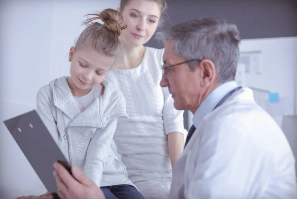 Klein meisje met haar moeder op consult bij een dokter — Stockfoto