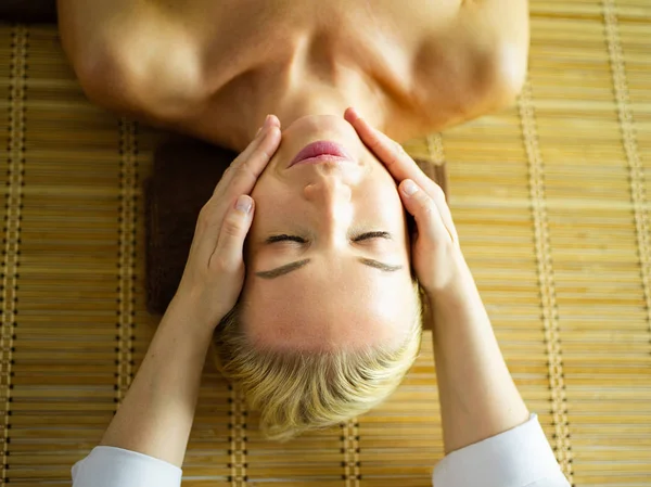 Hermosa mujer haciendo masaje facial en un salón de spa — Foto de Stock