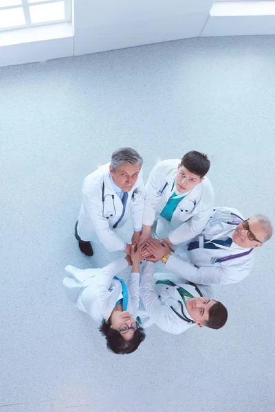 Medical team sitting and discussing at table, top view