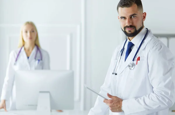 Equipo médico feliz de médicos, hombres y mujeres, aislados sobre fondo blanco en una habitación de hospital —  Fotos de Stock