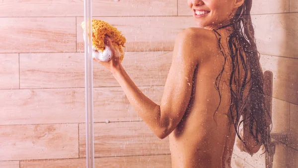 Young beautyful woman under shower in bathroom. — Stock Photo, Image