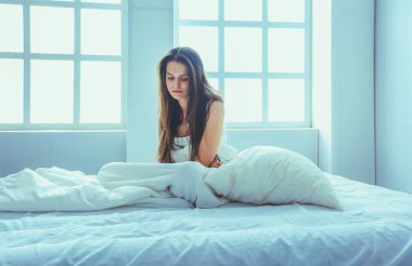 Genç kadın duygu ağrı yatakta.