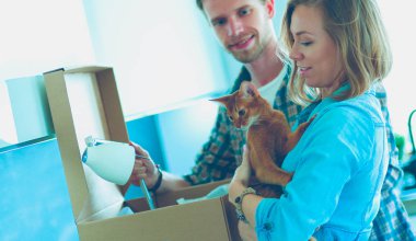 Genç bir çift yeni evde büyük karton kutu taşıyan. Ev taşıma. Genç Çift