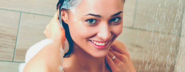 Young beautyful woman under shower in bathroom. — Stock Photo, Image