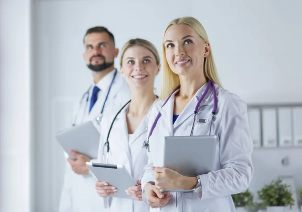 Smiling doctors all standing together as they work