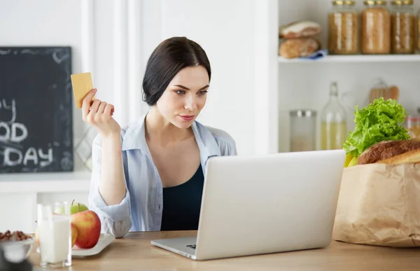 Young woman with her laptop at home — Stock Photo, Image