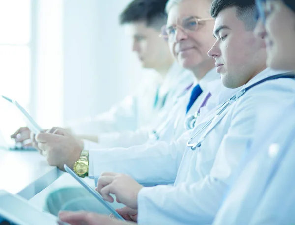 Medical team sitting and discussing at table — Stock Photo, Image