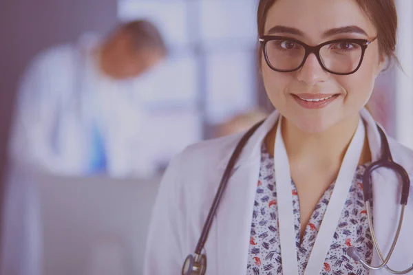 Female doctor using tablet computer in hospital lobby