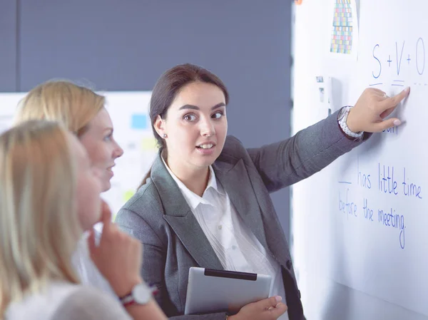 Business, education and office concept - business team with flip board in office discussing something. — Stock Photo, Image