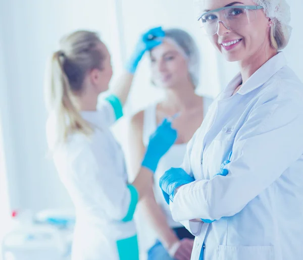 Beautiful woman face near doctor with syringe. — Stock Photo, Image