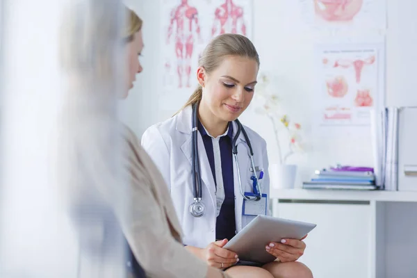 Doctor y paciente discutiendo algo mientras están sentados en la mesa. Concepto de medicina y salud — Foto de Stock